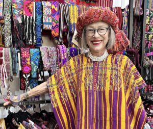 Norma Schafer standing in front of textiles